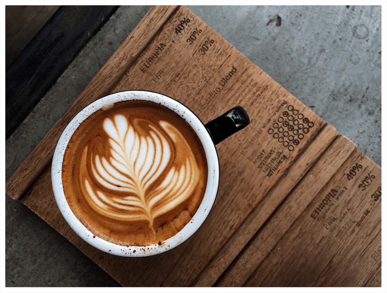 Cup of hot coffee on a wooden tablet