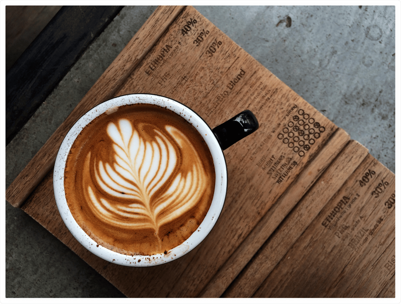 Cup of hot coffee on a wooden tablet